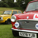 A red vintage Mini with a learner badge stuck to the front.